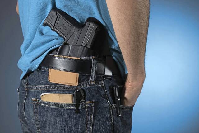 Man with gun in wasteband.