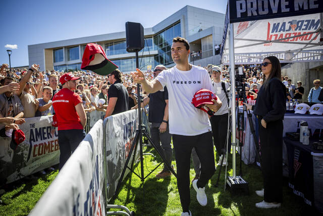 Charlie Kirk hands out hats before speaking at Utah Valley University in Orem, Utah, before he was fatally shot on September 10, 2025.